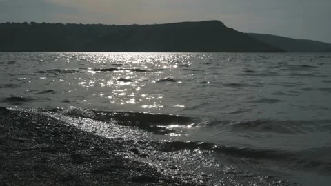 Small waves on the lake. View of the hills Stock Footage 256216084