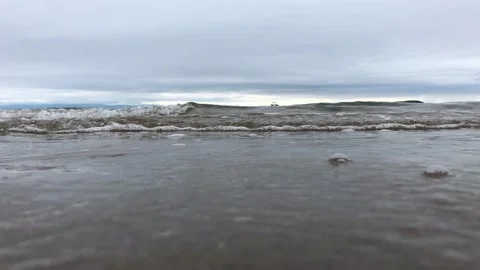 Small waves lap against the beach Stock Footage 138941707