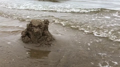 Small waves lap against the beach Stock Footage 138948508