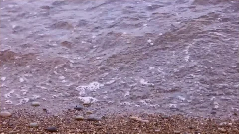 Small waves lapping on a pebble beach Stock Footage 77862886