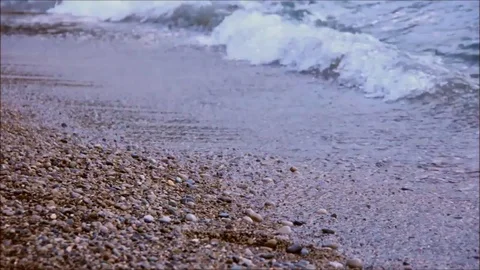 Small waves lapping on a pebble beach Stock Footage 77862892