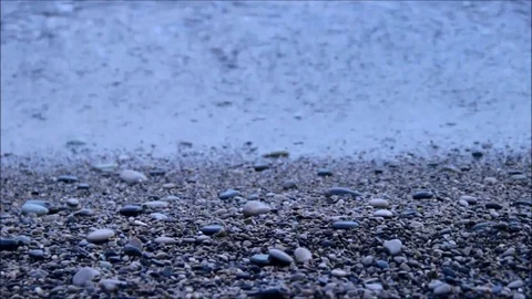 Small waves lapping on a pebble beach Stock Footage 77862900