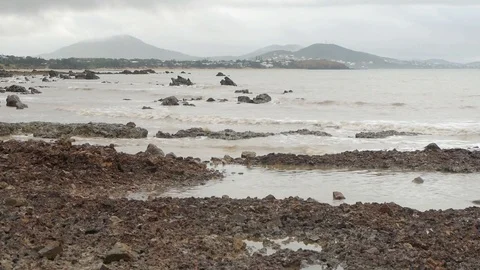 Small waves lapping at rocky shoreline Video stock 106341837