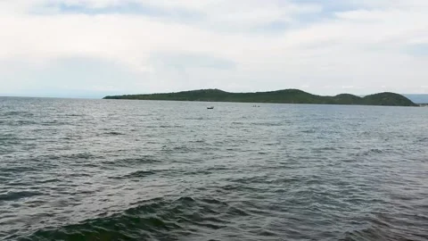 Small waves lapping on the shores of Lake Tanganyika Zambia gloomy skies and 3 Stock Footage 149117510