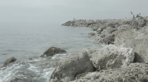 Small waves of Mediterranean sea beating against the rocks Stock Footage 41790690