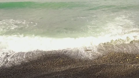 Small waves on a pebble beach Video stock 82930673
