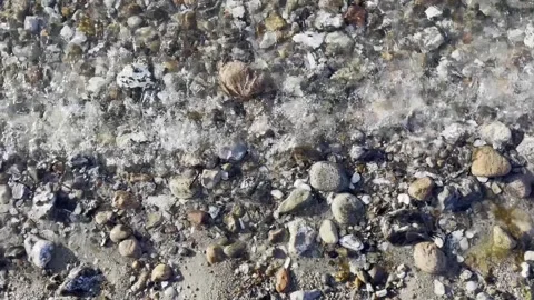 Small waves on pebbly beach Stock Footage 315285950