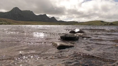 Small waves of a pond with mountains in the background 1 4K- Scotland Tongue Video stock 94870900