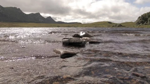 Small waves of a pond with mountains in the background 1 4K- Scotland Tongue Video stock 94870982