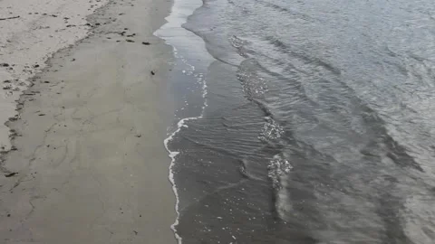 Small waves reaching a beach Stock Footage 255210437