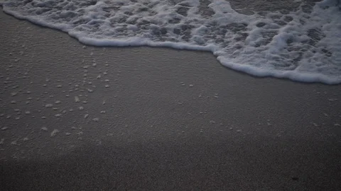 Small waves reaching the shore of a beach Stock Footage 125388291