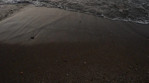 Small waves reaching the shore of a beach Stock Footage 125669500