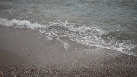 Small waves reaching the shore of a beach Stock Footage 125670234