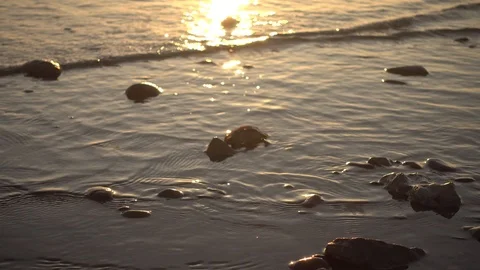 Small waves reaching the shore of a beach Stock Footage 125671451