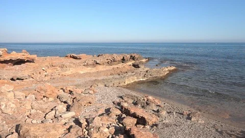 Small waves reaching the shore of a beach Stock Footage 125672575