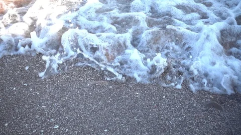 Small waves reaching the shore of a beach Stock-Footage 125672943