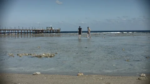 Small waves on the Red Sea in Egypt. people walk in shallow water Stock Footage 122455746