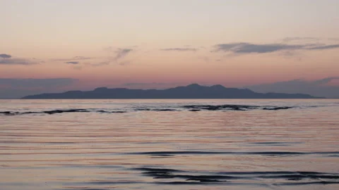 Small waves ripple toward shore of Great Salt Lake at Sunset. 4K Stock Footage 231544992