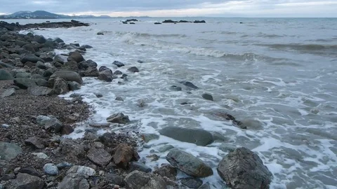 Small waves on rocky beach Stock Footage 106326086