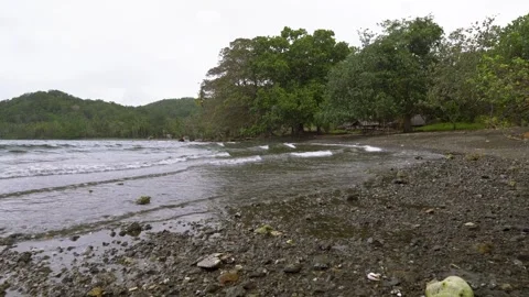 Small waves on a rocky beach Stock Footage 267789991