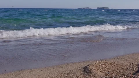 Small waves rolling onto sandy beach, calm sea Video stock 327830812