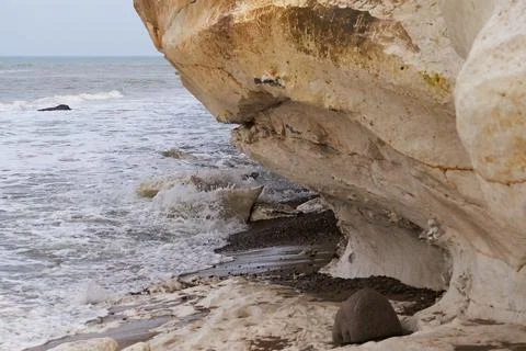Small waves rolling under the limestone cliff at Bulbjerg in Denmark Stock Photos