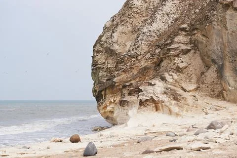Small waves rolling under the limestone cliff at Bulbjerg in Denmark Stock Photos