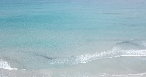 Small waves rolling on white sand beach tourist destination Stock Footage 112056986