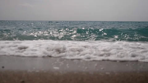 Small waves on a sandy beach Видео 248759598
