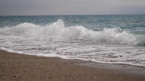 Small waves on a sandy beach Stock Footage 249054222