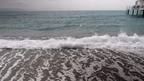 Small waves on a sandy beach Stock Footage 250782436