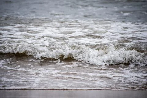 Small waves on the sea coast, foaming waves Stock Photos