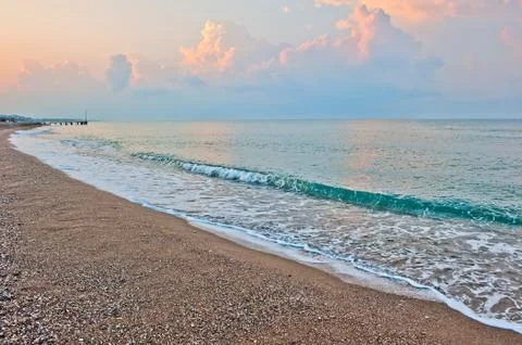 Small waves of the sea at dawn Stock Photos