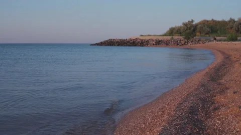 Small waves on the sea surface. Beautiful sea coast on the sunrise Stock Footage 159280132