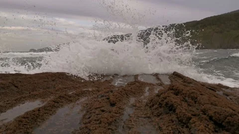 Small waves shocking against the rocks Stock Footage 130983905
