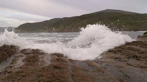 Small waves shocking against the rocks Stock Footage 130984003