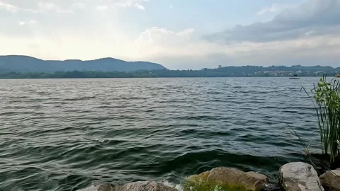 Small waves on the shore of Lake Comabbio Stock Footage 311206706