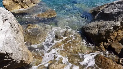 Small waves splashing on the rocks Stock Footage 92931228