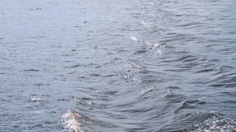 Small waves spread on sea water behind sailing yacht closeup Stock Footage 138728087