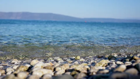 Small Waves Spreading Across a Pebble Beach Stock Footage 347017110