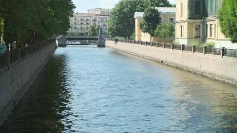 Small waves spreading out flowing water in the city channel Stock Footage 161038496