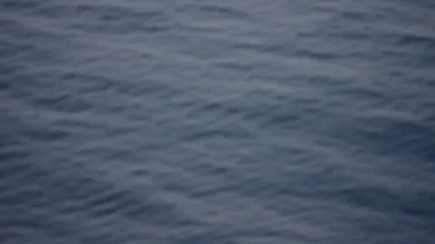 Small waves on the surface of a deep blue water Stock Footage 72602775