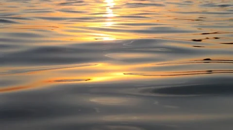Small waves on a surface sea at sunset or sunrise Video stock 64309675