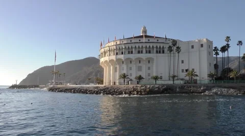 Small waves surge on the rock jetty with Casino bathed in morning light peace Stock Footage 67970737