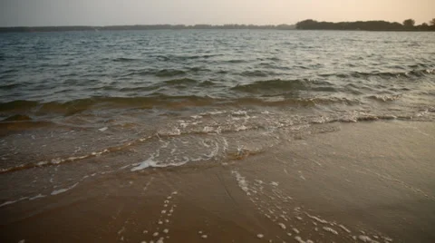 Small waves washing onshore over sand Stock Footage 32256770