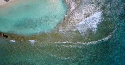 Small waves washing over a reef into a tide pool off the coast of Hawaii Stock Footage 118080585