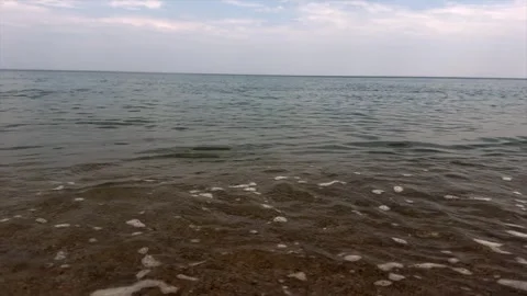 Small waves washing over sandy shore in tranquil seaside setting. Calm sea Stock Footage 337105131