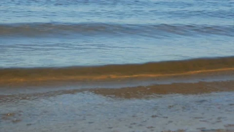 Small waves of water over the sandy golden seabed Stock Footage 139850198