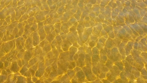 Small waves of water over the sandy golden seabed Stock Footage 139850235