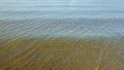 Small waves of water over the sandy golden seabed Stock Footage 139850236